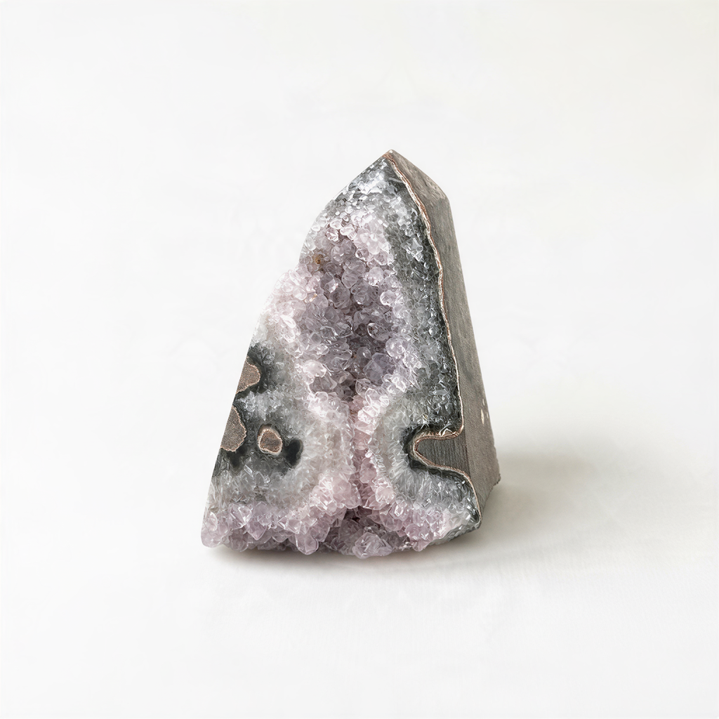 A single, unique crystal formation with a jagged, triangular shape and a mix of purple and gray hues.