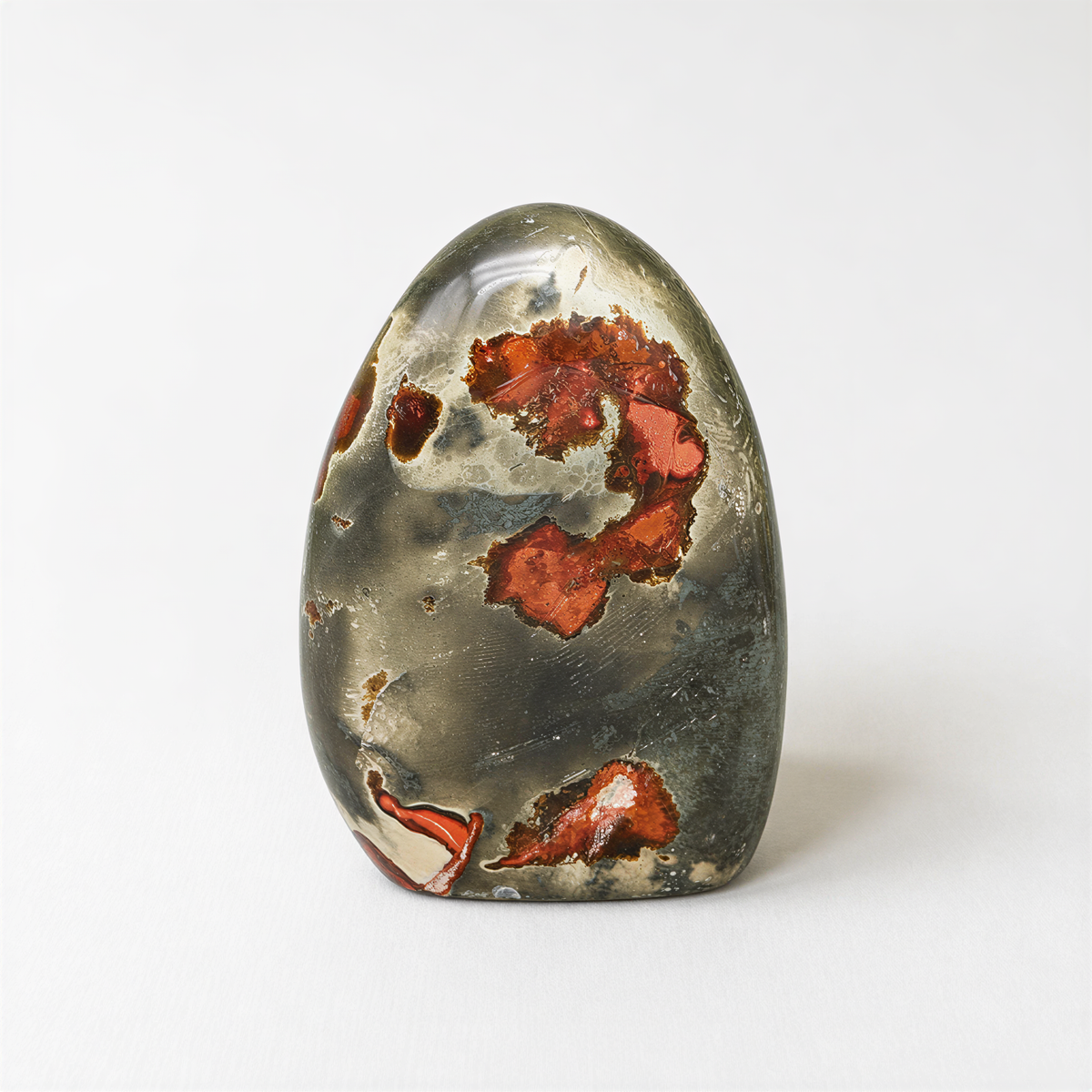 a piece of jade with a unique, colorful pattern of red and orange hues.