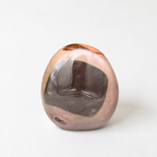 a single, round, brown and black stone or gemstone, which appears to be a natural stone or gemstone.