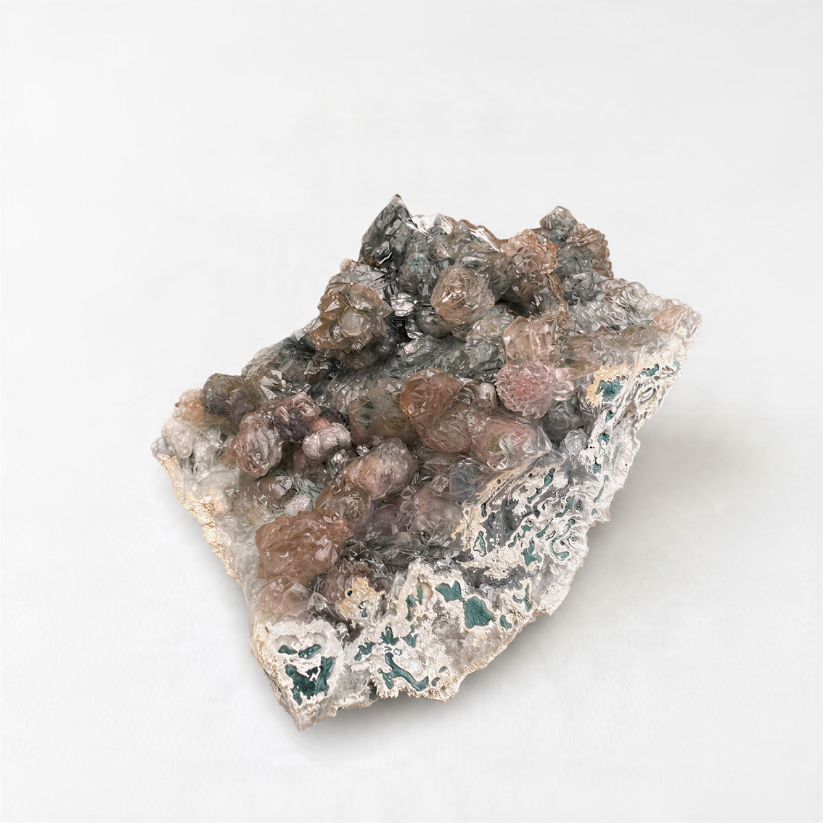 a close-up of a rock with a variety of minerals and crystals, including shades of brown, gray, and green.