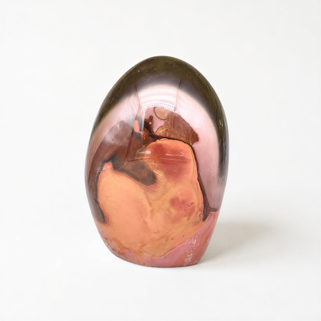 a unique, abstract, and colorful piece of art, possibly a sculpture or a ceramic piece, with a mix of orange, brown, and green colors.