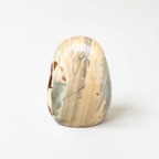 a single, round, stone-like object with a unique, textured surface.