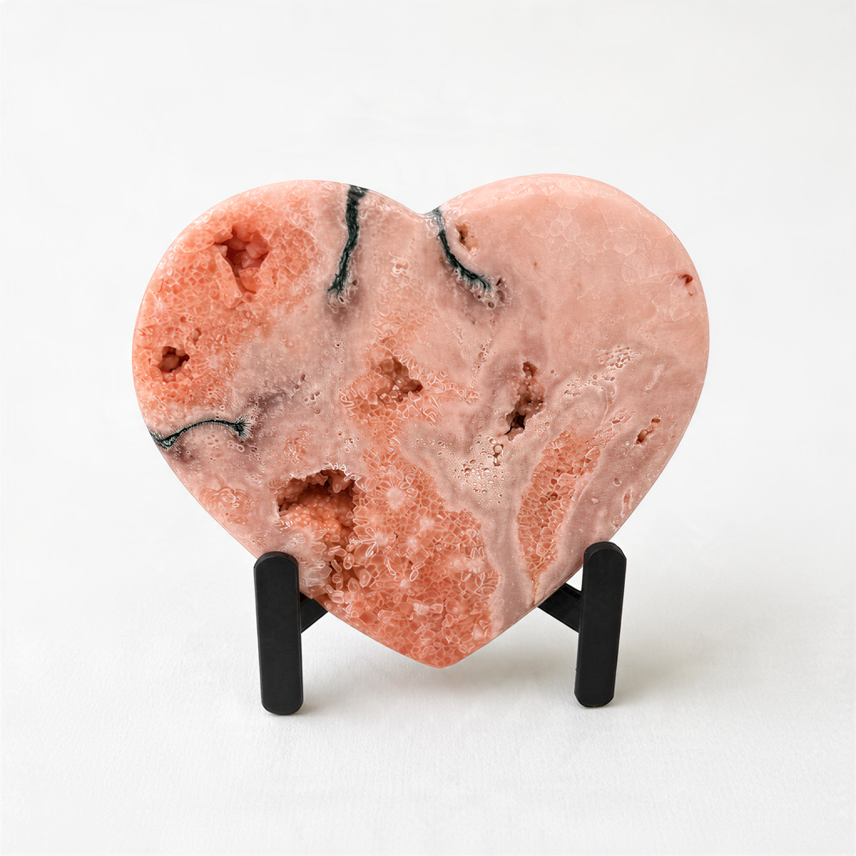 a heart-shaped pink rock with a unique, textured surface.