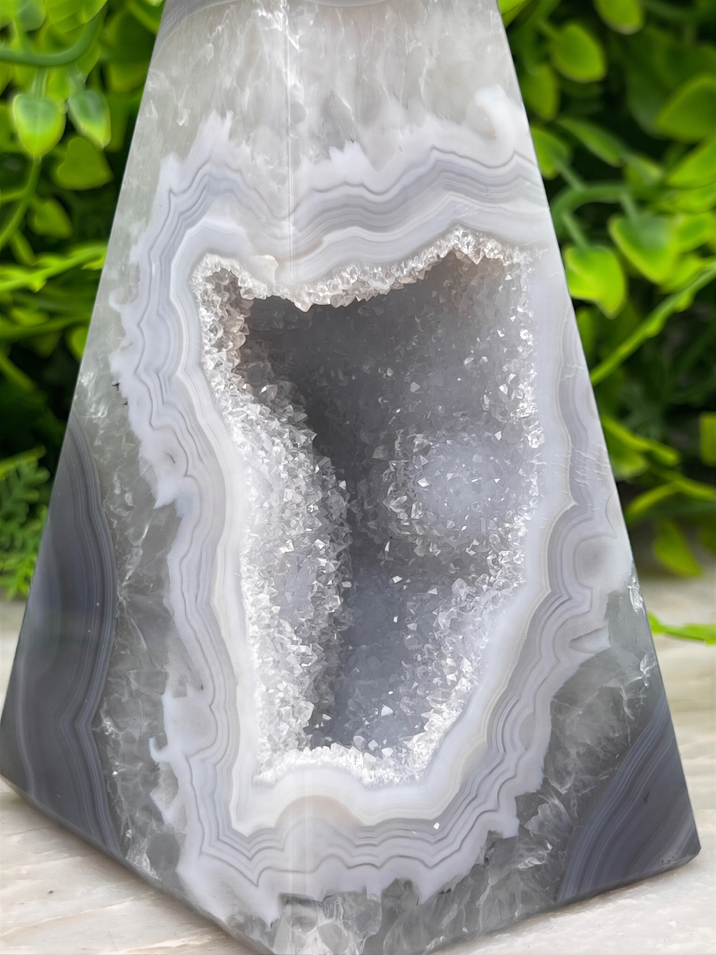 A close-up image of a geode with a large, open cavity revealing the crystals inside.